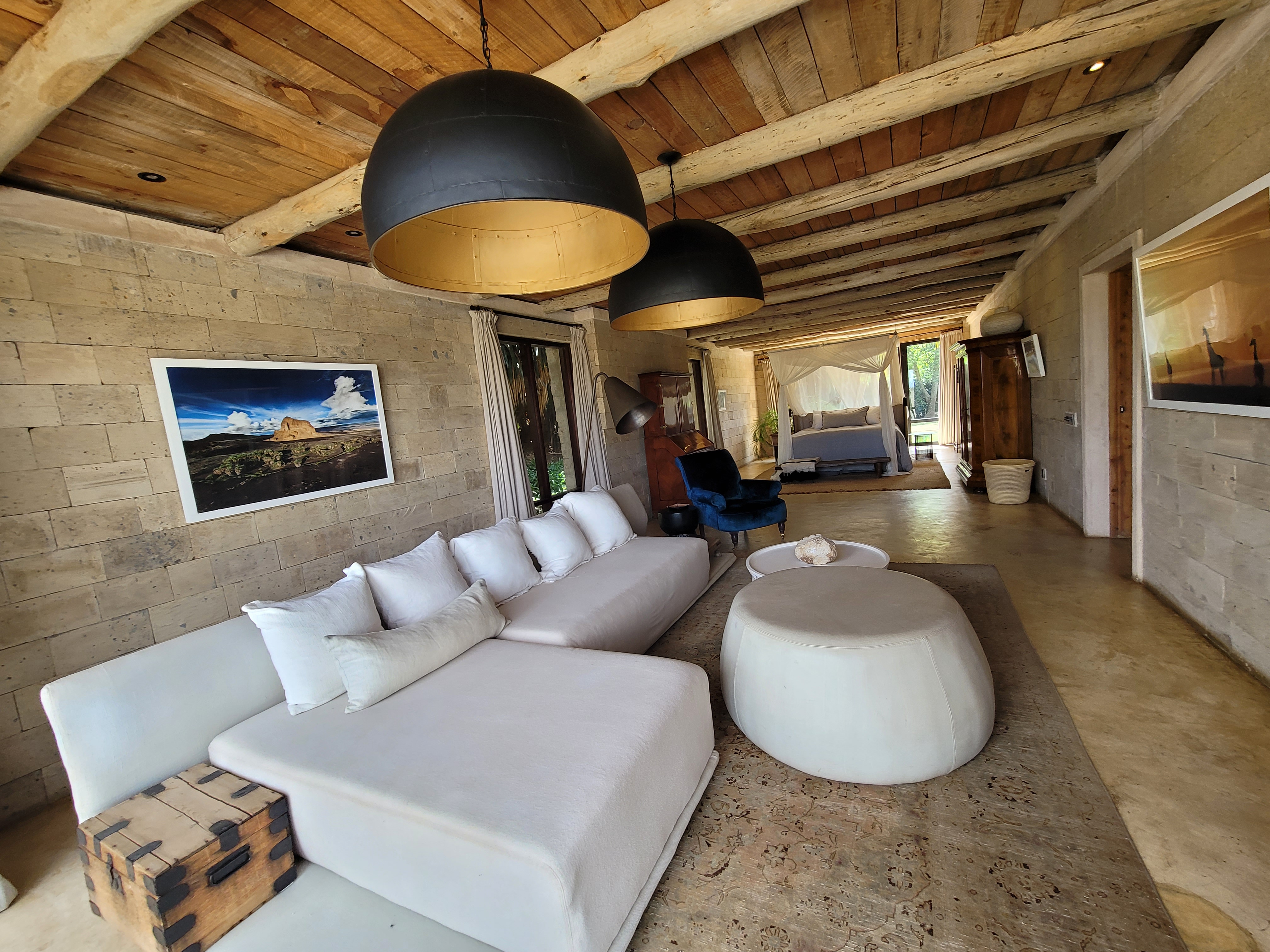 Cozy eco-lodge room with natural wood furnishings and bush views